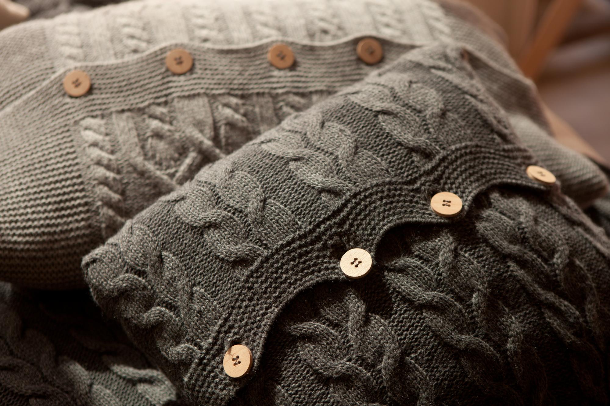 Detail of visible mending on a wool sweater